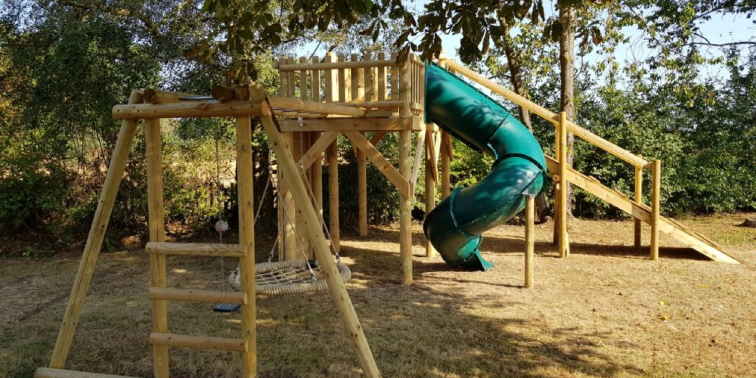 basket monkey bar swing set attached to zip wire platform