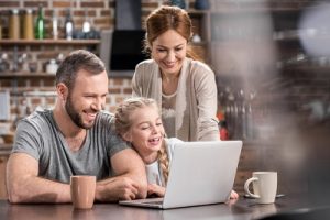 A family looking at different climbing frame variations on the internet