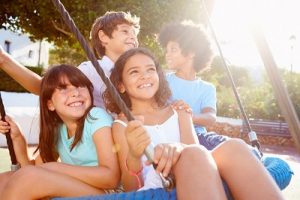 Group of children swinging on a nest swing