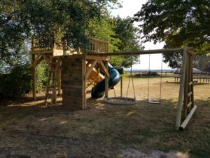 back of zip wire play platform with swing set