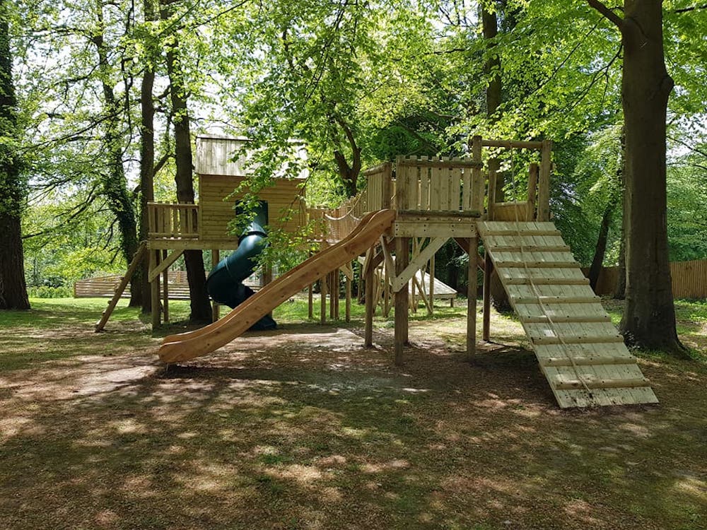 Play platform With Tree House in the Distance - Wooden Climbing Frame ...