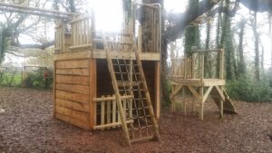 Tower with hide out, cargo net, rope bridge and trapeze bar
