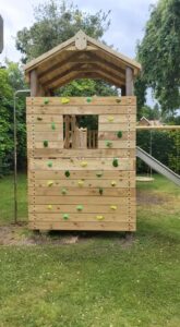 Tower with climbing wall, slide and fireman pole